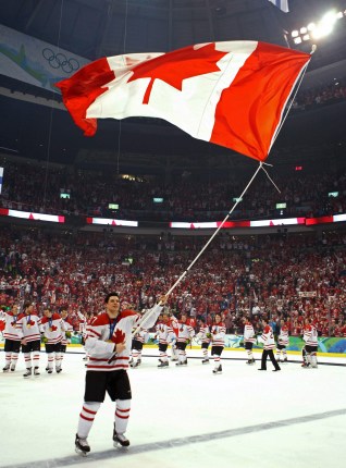 Canada's Sidney Crosby skates with tha flag after scoring the overtime winning goal in men's ice hockey gold medal final at the 2010 Winter Olympic Games in Vancouver, Sunday, Feb. 28, 2010. THE CANADIAN PRESS/Jonathan Hayward