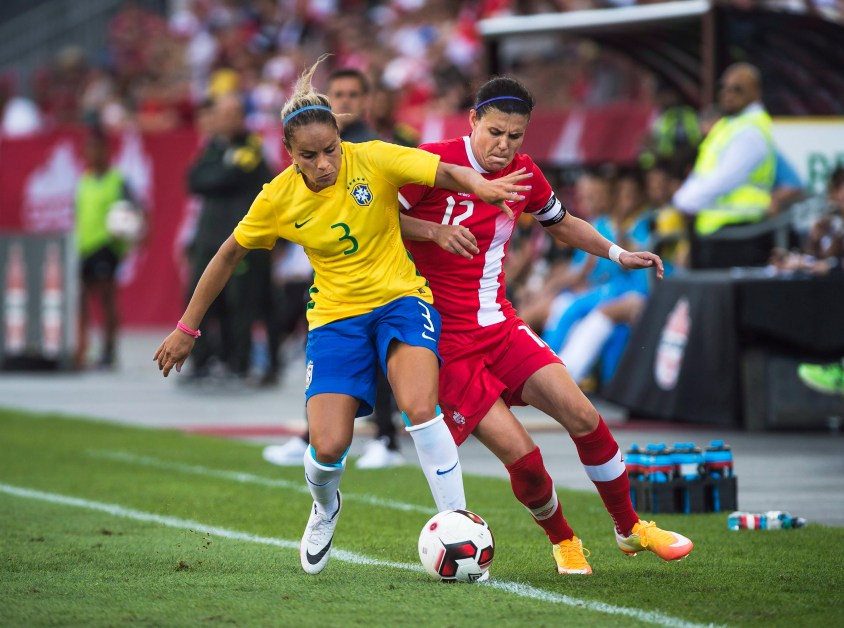Canada's Christine Sinclair (12) battles for the ball against Brazil's Monica (3) during first half in a friendly match for the Road To Rio in Toronto, Saturday, June 04, 2016. THE CANADIAN PRESS/Aaron Vincent Elkaim