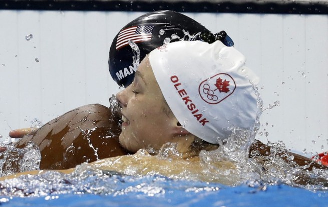 Penny Oleksiak célèbre sa médaile d'or avec l'Américaine Simone Manuel, au 100 m style libre. AP Photo/Martin Meissner