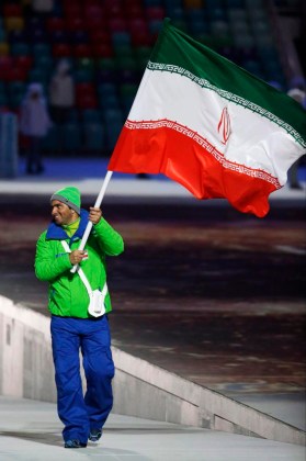 Hossein Saveh Shemshaki d'Iran porte le drapeau national lors de la cérémonie d'ouverture des Jeux olympiques d'hiver de 2014 à Sotchi, en Russie, le vendredi 7 février 2014. (AP Photo / Mark Humphrey)
