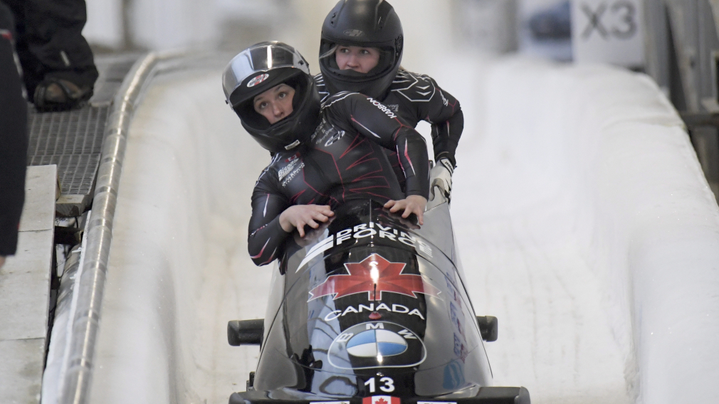 Deux athlètes de bobsleigh en fin de course. 