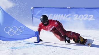 Un athlète de snowboard dévale la pente à toute vitesse