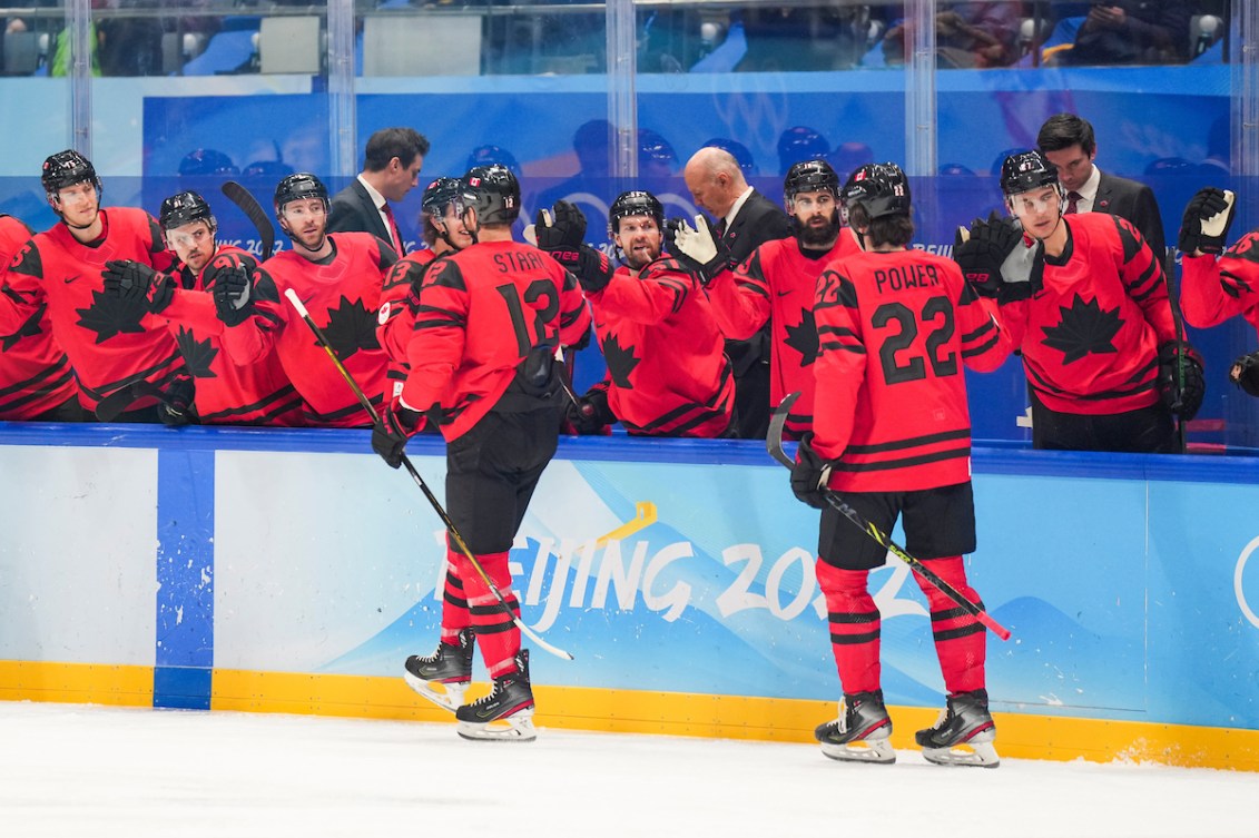 Eric Staal #12 d'Équipe Canada célèbre son but contre les États-Unis avec ses coéquipiers à son retour au banc. 