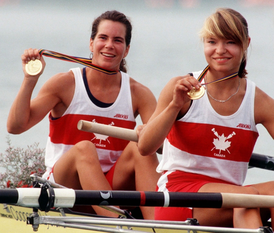 Marnie McBean et Kathleen Heddle siègent dans leur aviron et montrent leurs médaille d'or en souriant après leur victoire à Barcelone 1992