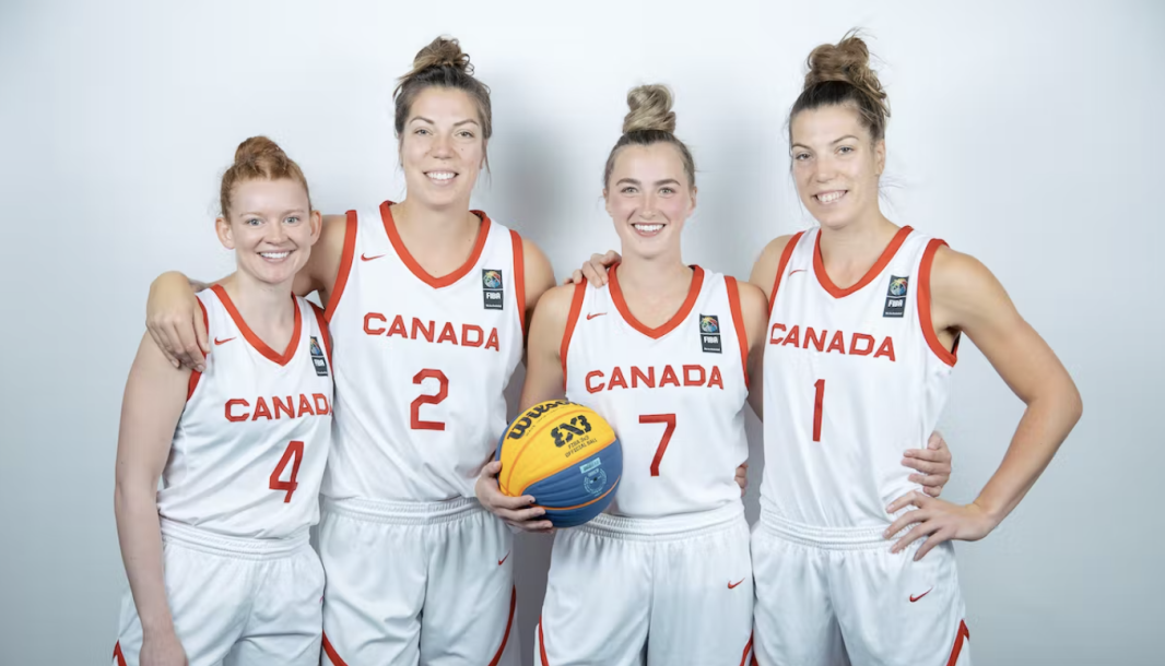 Quatre joueuses de basketball posent pour la caméra.