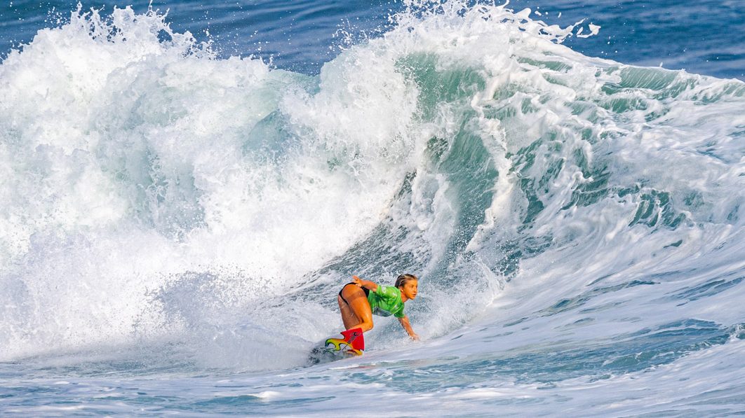 Erin Brooks surfe sur une grosse vague sur une planche de surf
