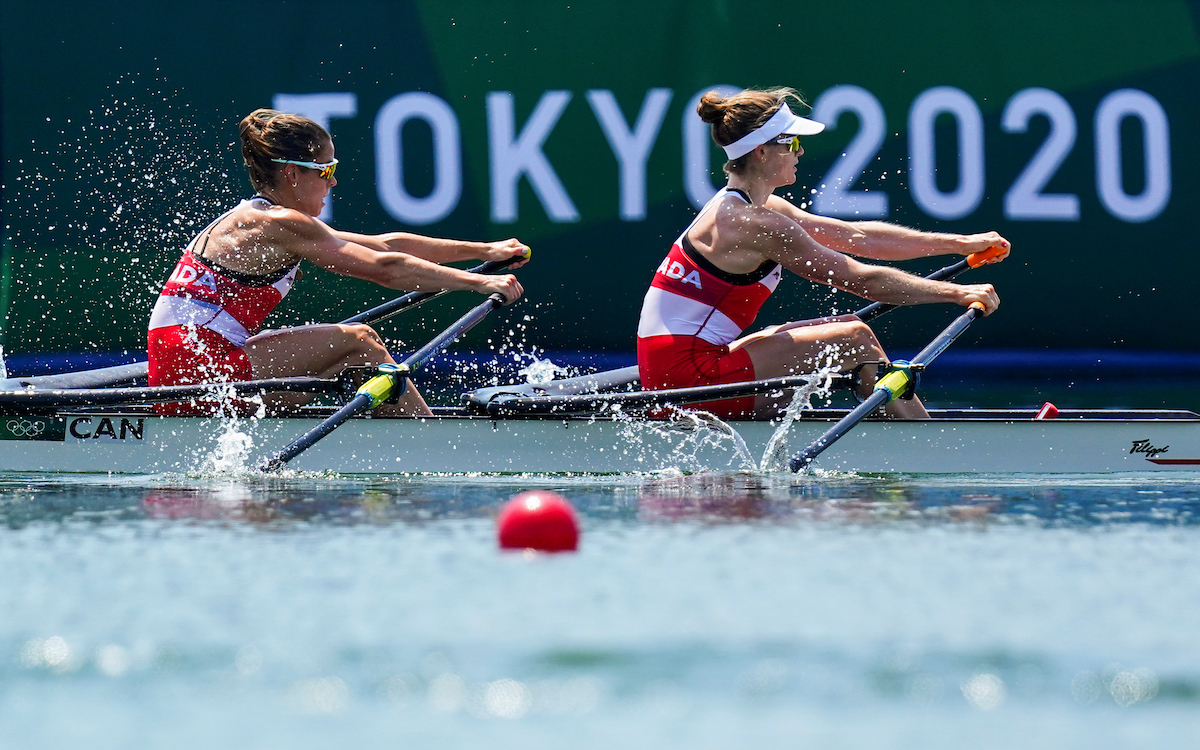 Deux athlètes féminines d'aviron pendant une course.