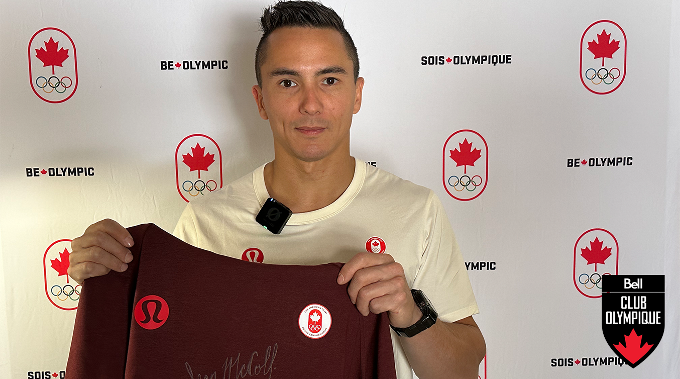 Sean McColl holding a signed sweater