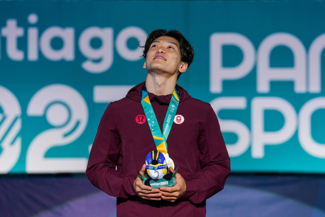 Philip Kim sur le podium avec une médaille d'or et une peluche de la mascotte des Jeux panaméricains. 