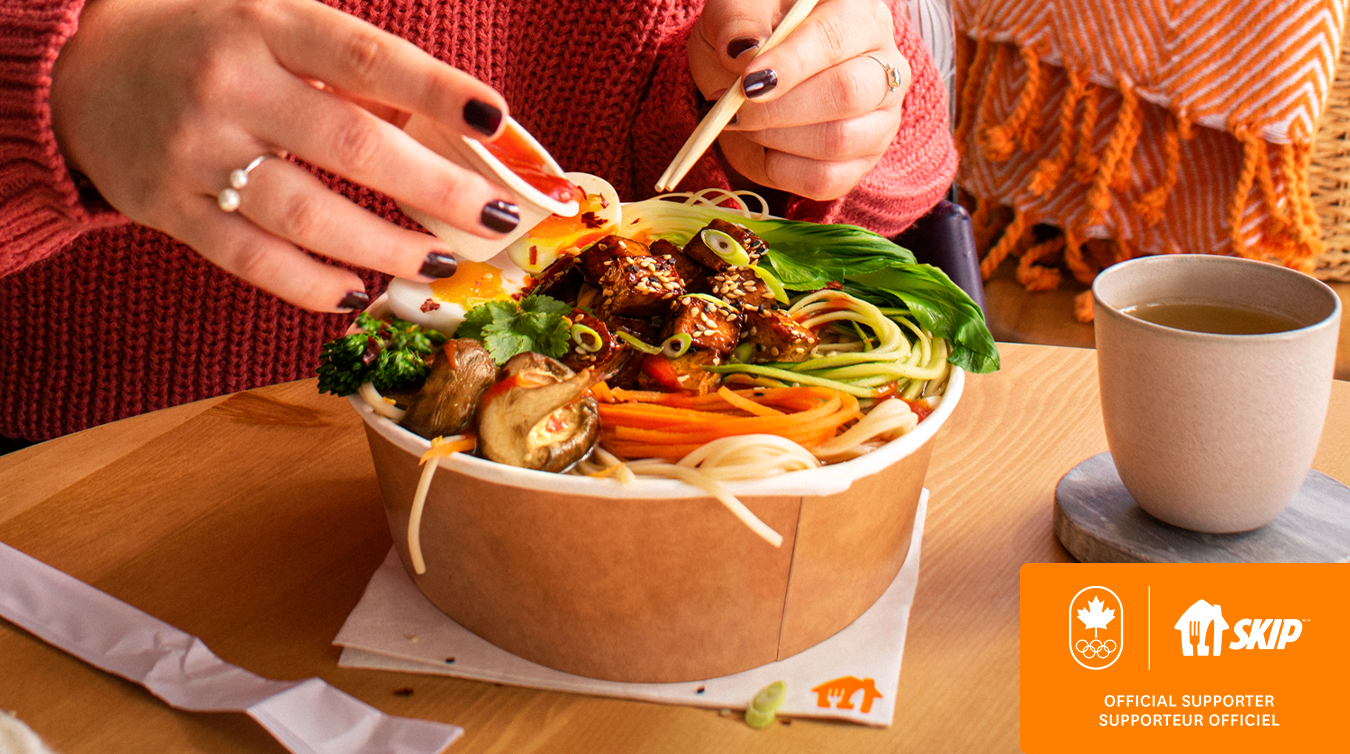 person holding chopsticks over a bowl of food