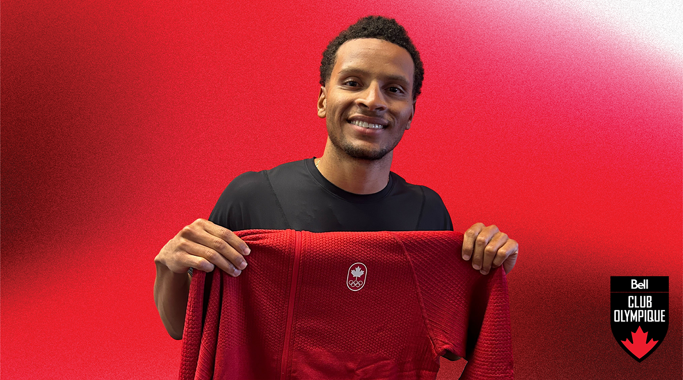 Andre De Grasse holding a signed sweater