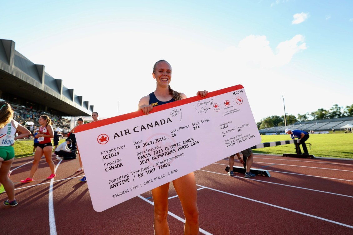 Ceili McCabe pose pour une photo avec un billet d'avion géant pour Paris 2024.