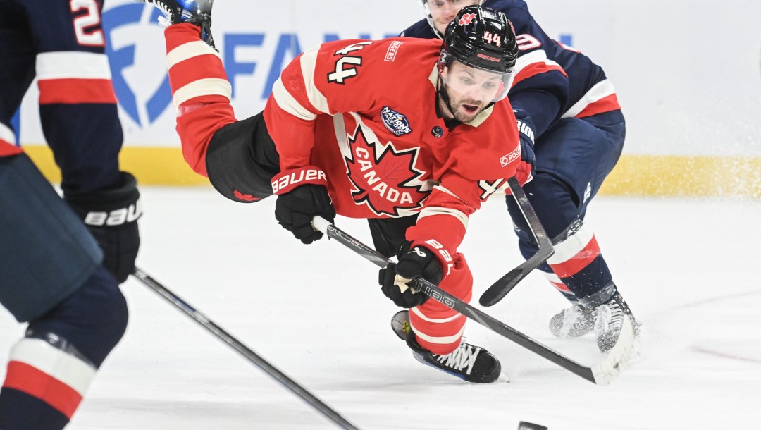 Josh Morrissey fait une passe en tombant sur la glace.