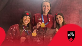 the Canadian women's team pursuit team smiling and holding a signed jacket and their gold medals