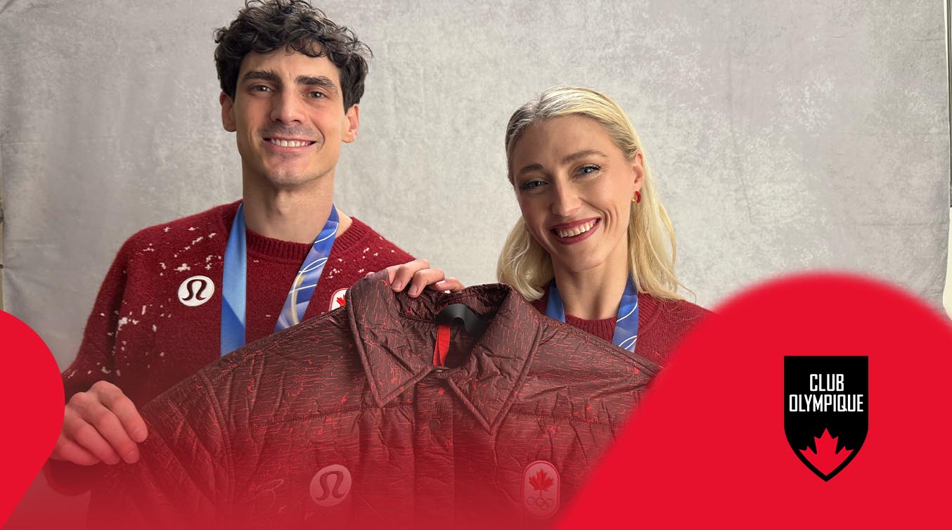 Piper and Paul smiling and holding a Team Canada Jacket