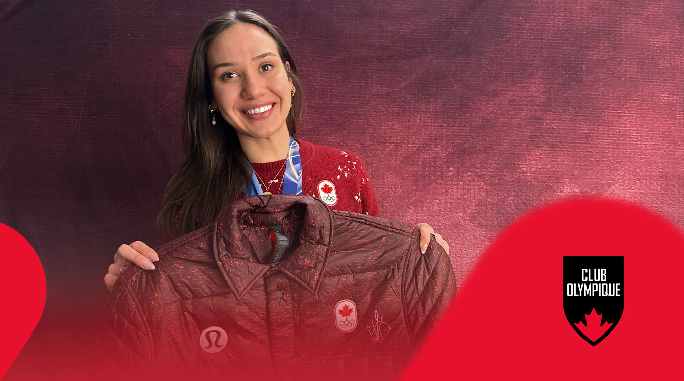 Courtney Sarault smiling and holding a signed jacket