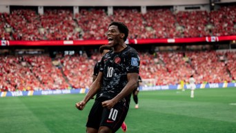 Jonathan David celebrates scoring against Qatar on Thursday.